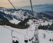Families enjoying a chair lift ride in snowy mountains of northern Pakistan during a winter vacation