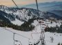 Families enjoying a chair lift ride in snowy mountains of northern Pakistan during a winter vacation
