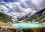 People enjoying a serene lake surrounded by mountains and greenery in Northern Pakistan
